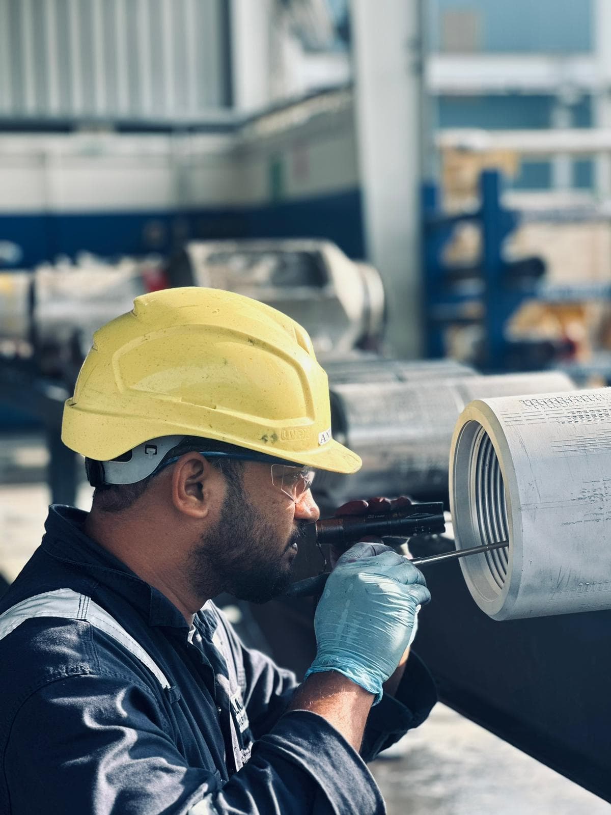 Blacktech technician inspecting threaded tubular equipment