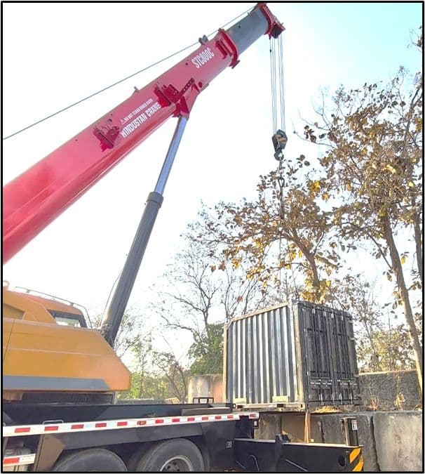 Red crane lifting container